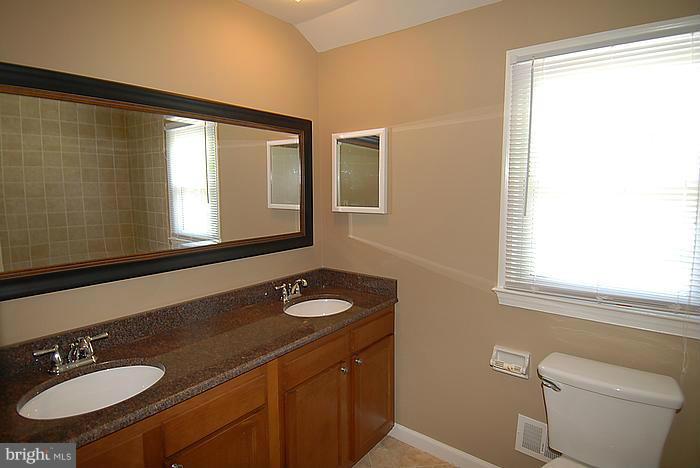 409 Highgate Terrace Silver Spring, MD 20904 - Photo 24 of 30 a bathroom with a granite countertop sink toilet a mirror and shower