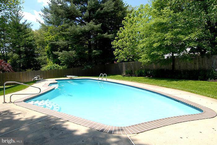 409 Highgate Terrace Silver Spring, MD 20904 - Photo 30 of 30 a view of a swimming pool with a yard and large trees