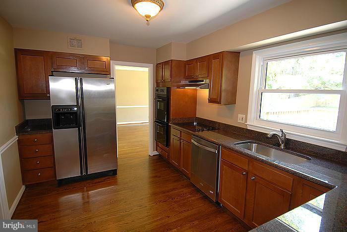 409 Highgate Terrace Silver Spring, MD 20904 - Photo 10 of 30 a kitchen with stainless steel appliances granite countertop a refrigerator and a sink