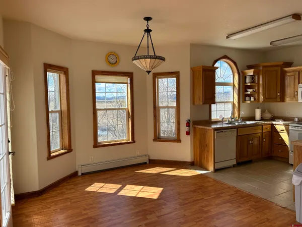 a kitchen with a stove a refrigerator and a sink