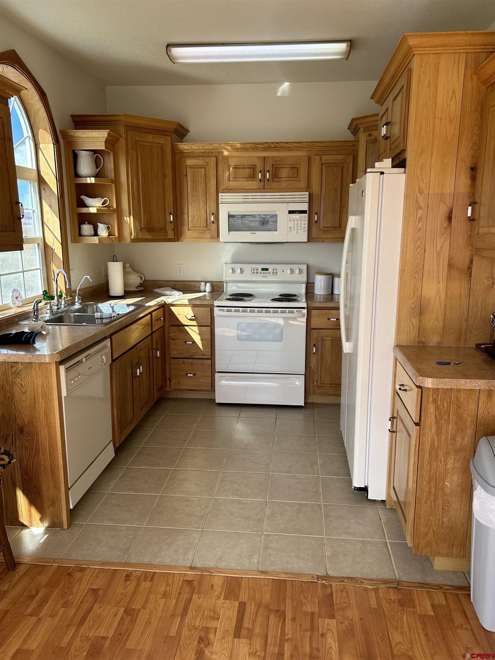 32116 Highway 145 Redvale, CO 81431 - Photo 12 of 28 a kitchen with a stove a refrigerator and a sink