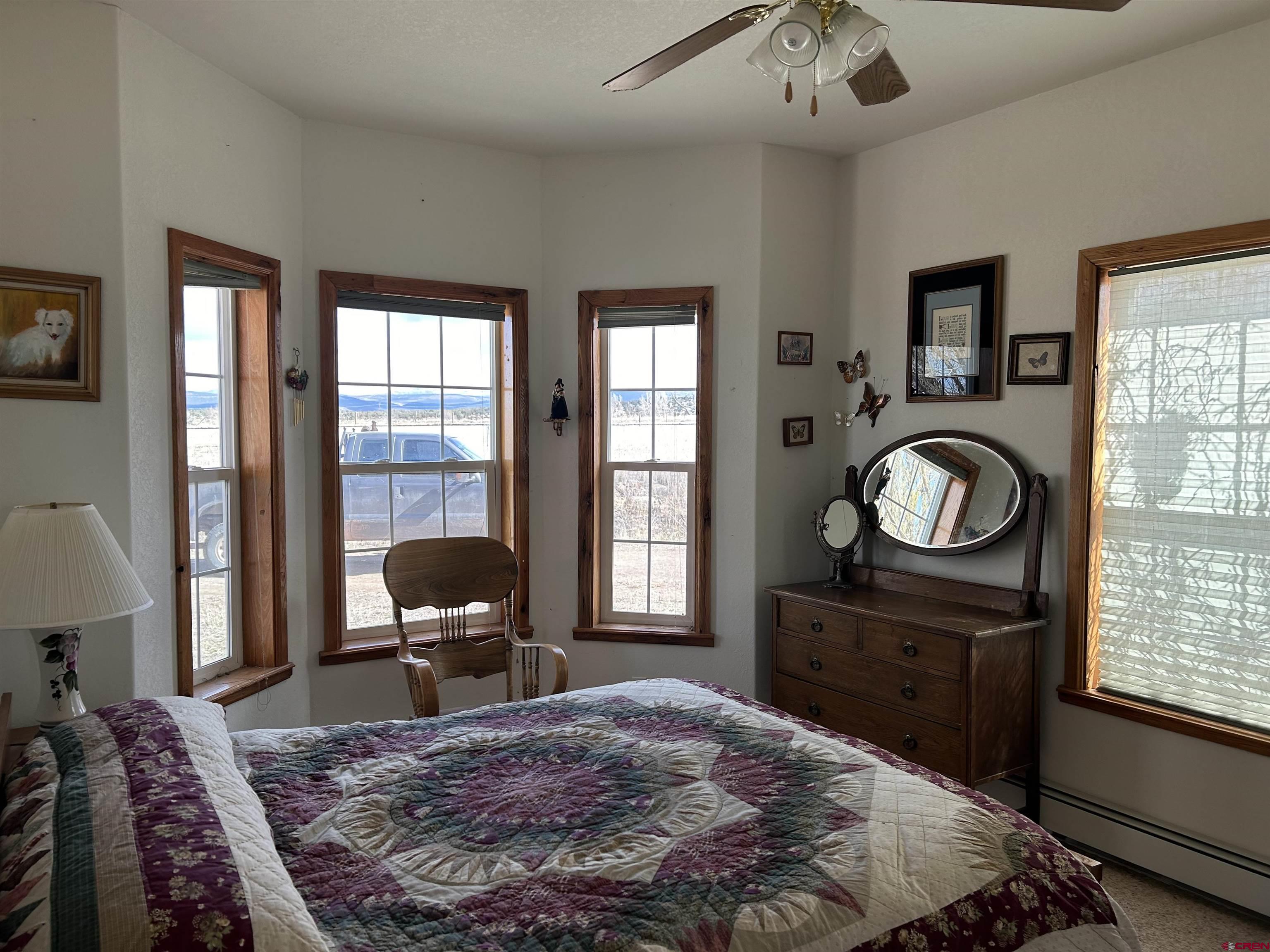 32116 Highway 145 Redvale, CO 81431 - Photo 13 of 28 a bedroom with a bed and wooden floor