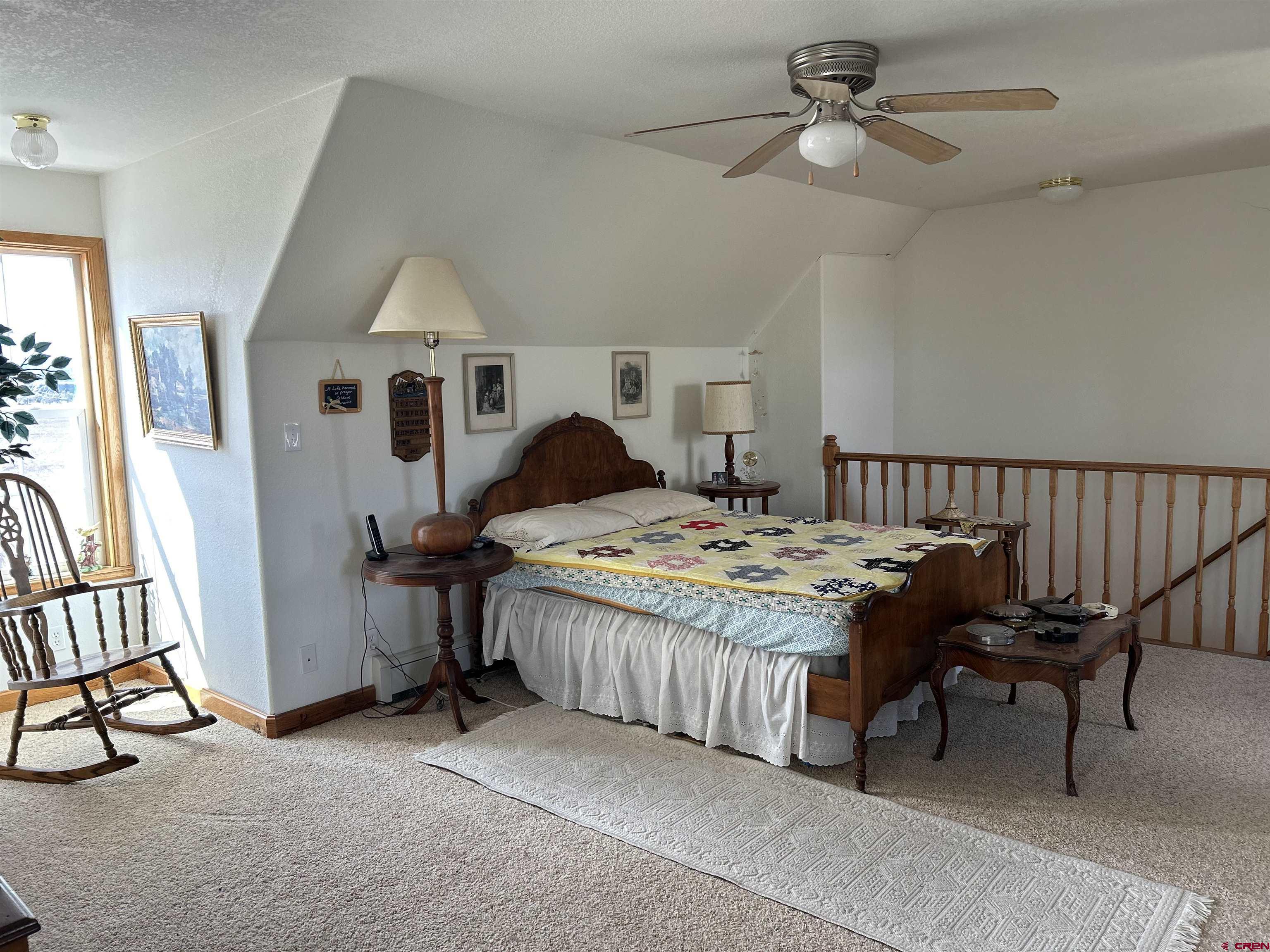 32116 Highway 145 Redvale, CO 81431 - Photo 18 of 28 a bedroom with a bed and a chandelier