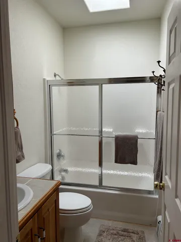 a bathroom with a toilet a sink and a window