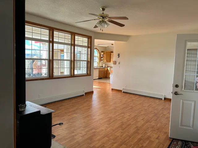 a view of a livingroom with a window and wooden floor