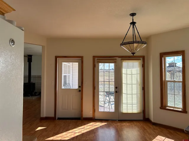a view of a kitchen with an entryway and a window