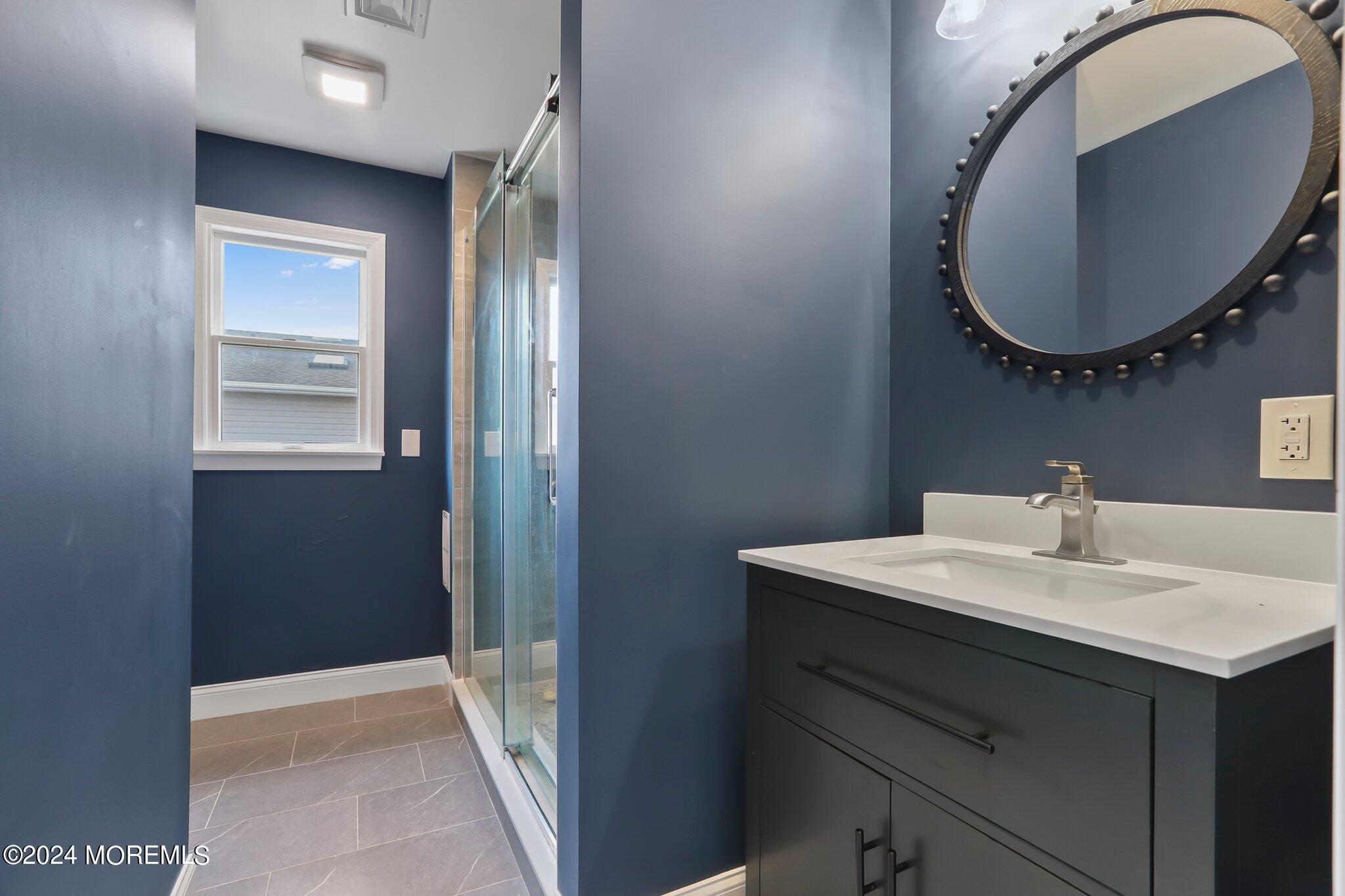 1419 Joseph Street Point Pleasant, NJ 08742 - Photo 12 of 27 a bathroom with a sink a vanity and a mirror