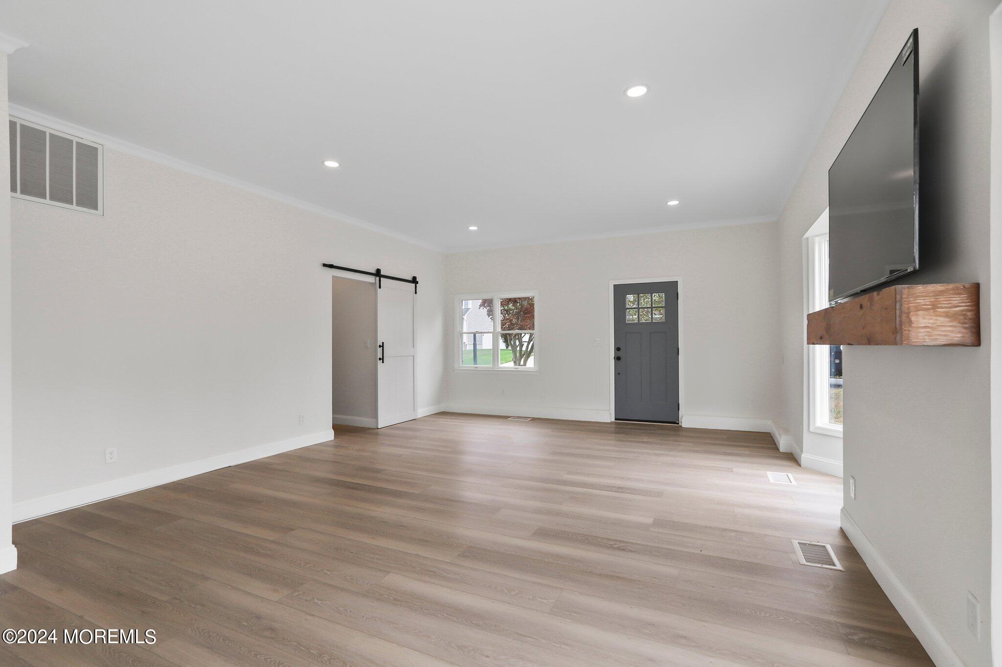 1419 Joseph Street Point Pleasant, NJ 08742 - Photo 18 of 27 a view of an empty room with wooden floor and a window