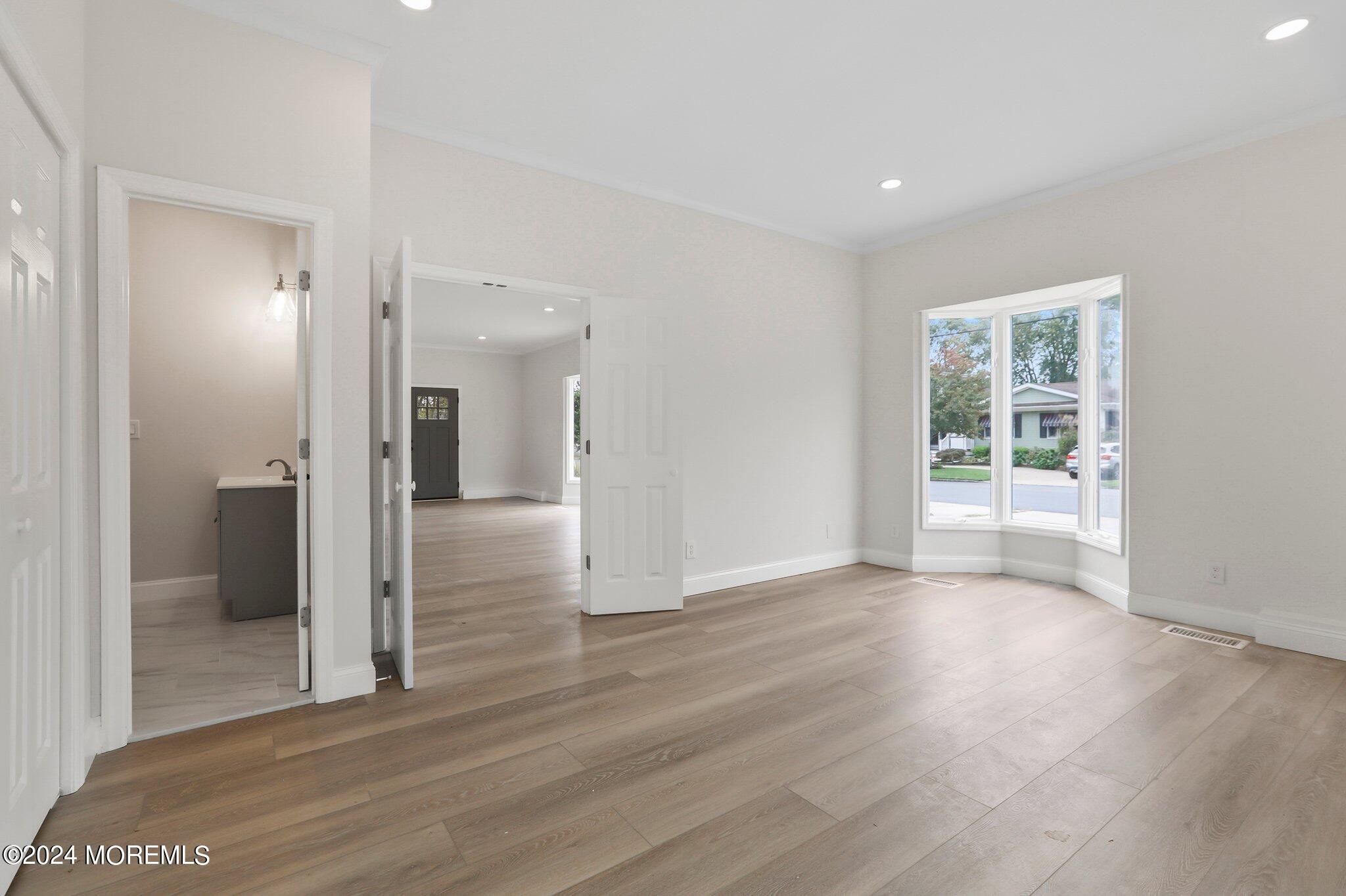 1419 Joseph Street Point Pleasant, NJ 08742 - Photo 20 of 27 a view of a hallway with wooden floor and a bathroom