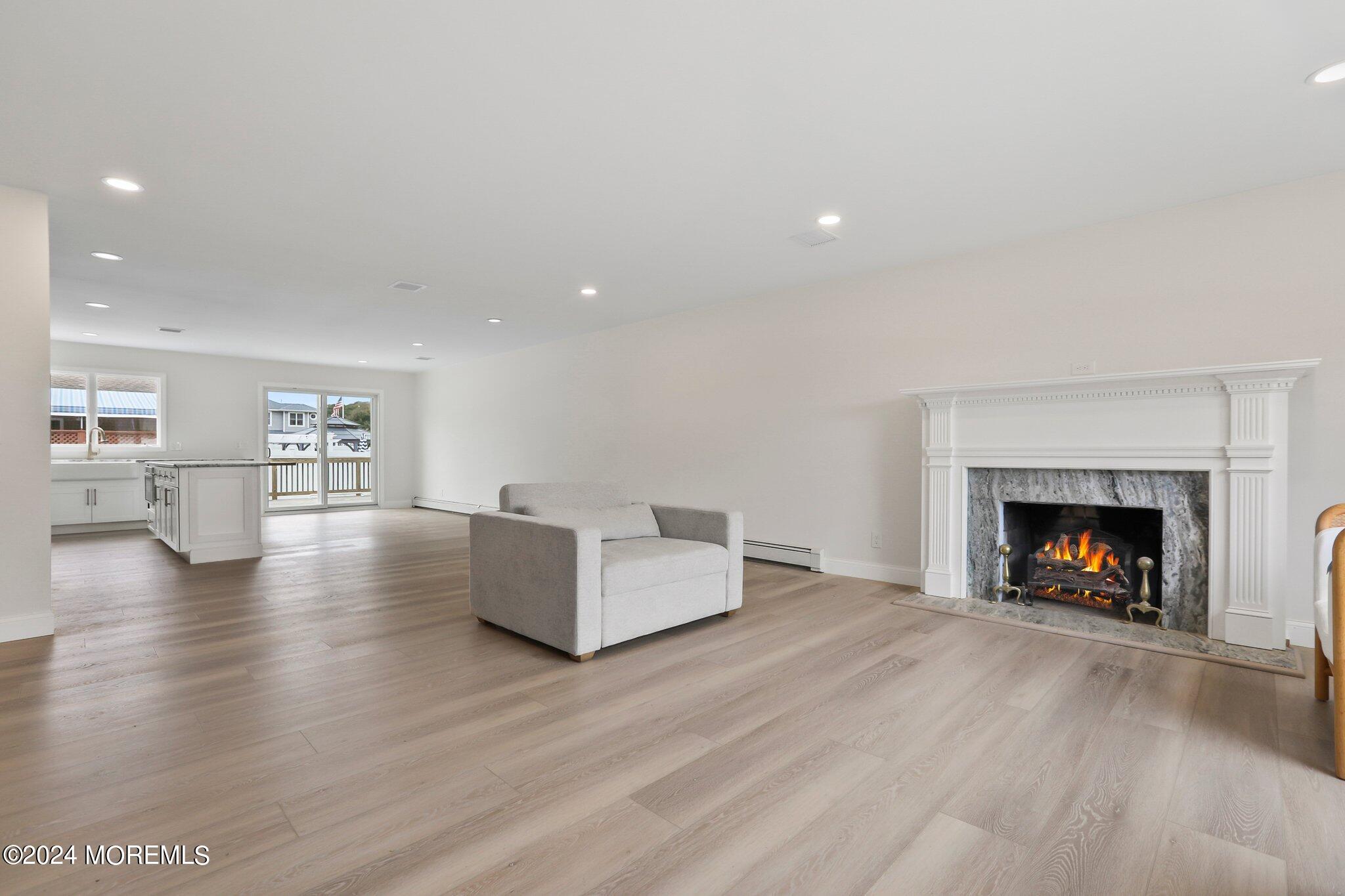 1419 Joseph Street Point Pleasant, NJ 08742 - Photo 2 of 27 a living room with furniture and a fireplace with wooden floor