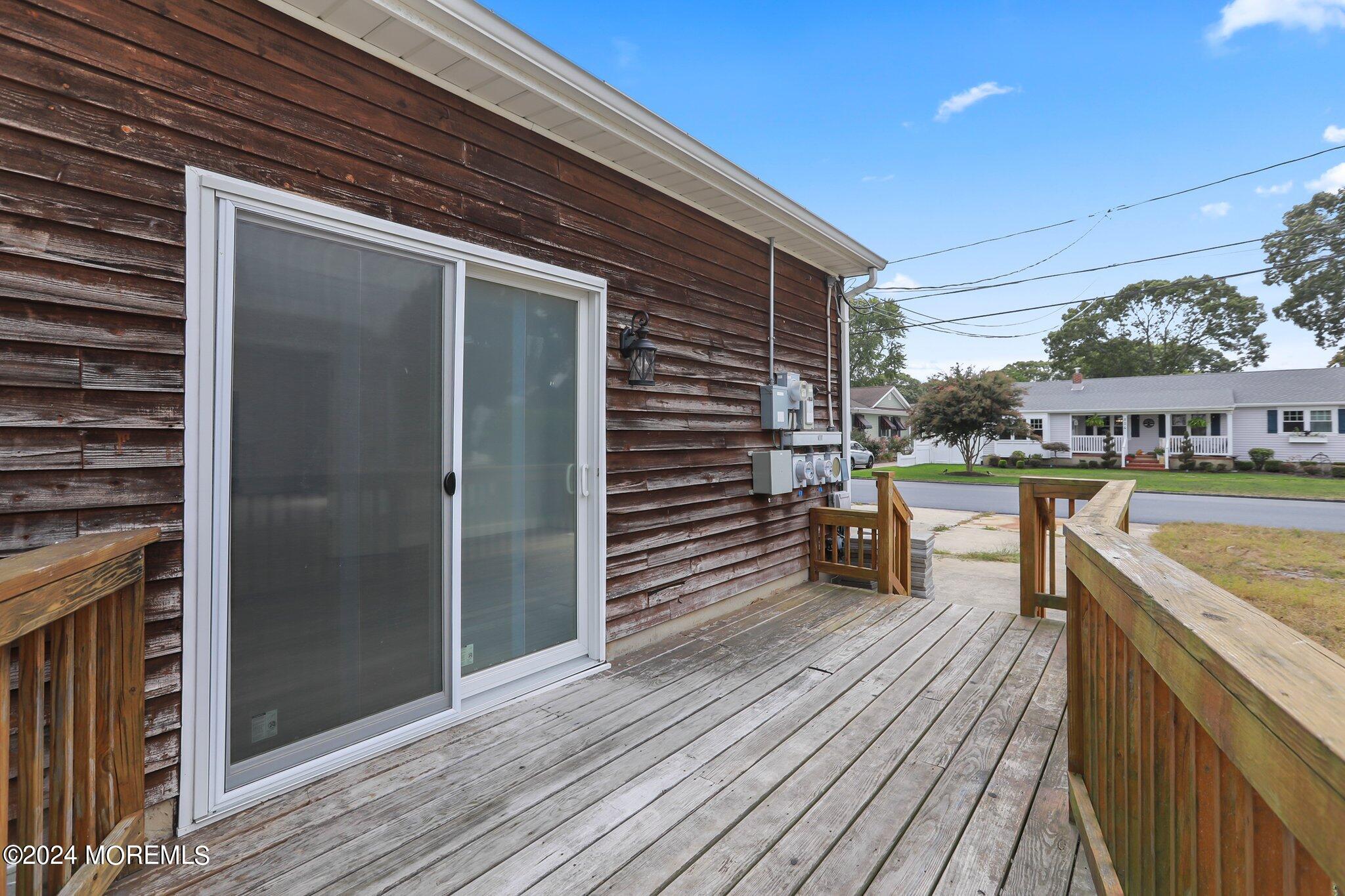 1419 Joseph Street Point Pleasant, NJ 08742 - Photo 24 of 27 a view of a balcony with furniture and wooden floor