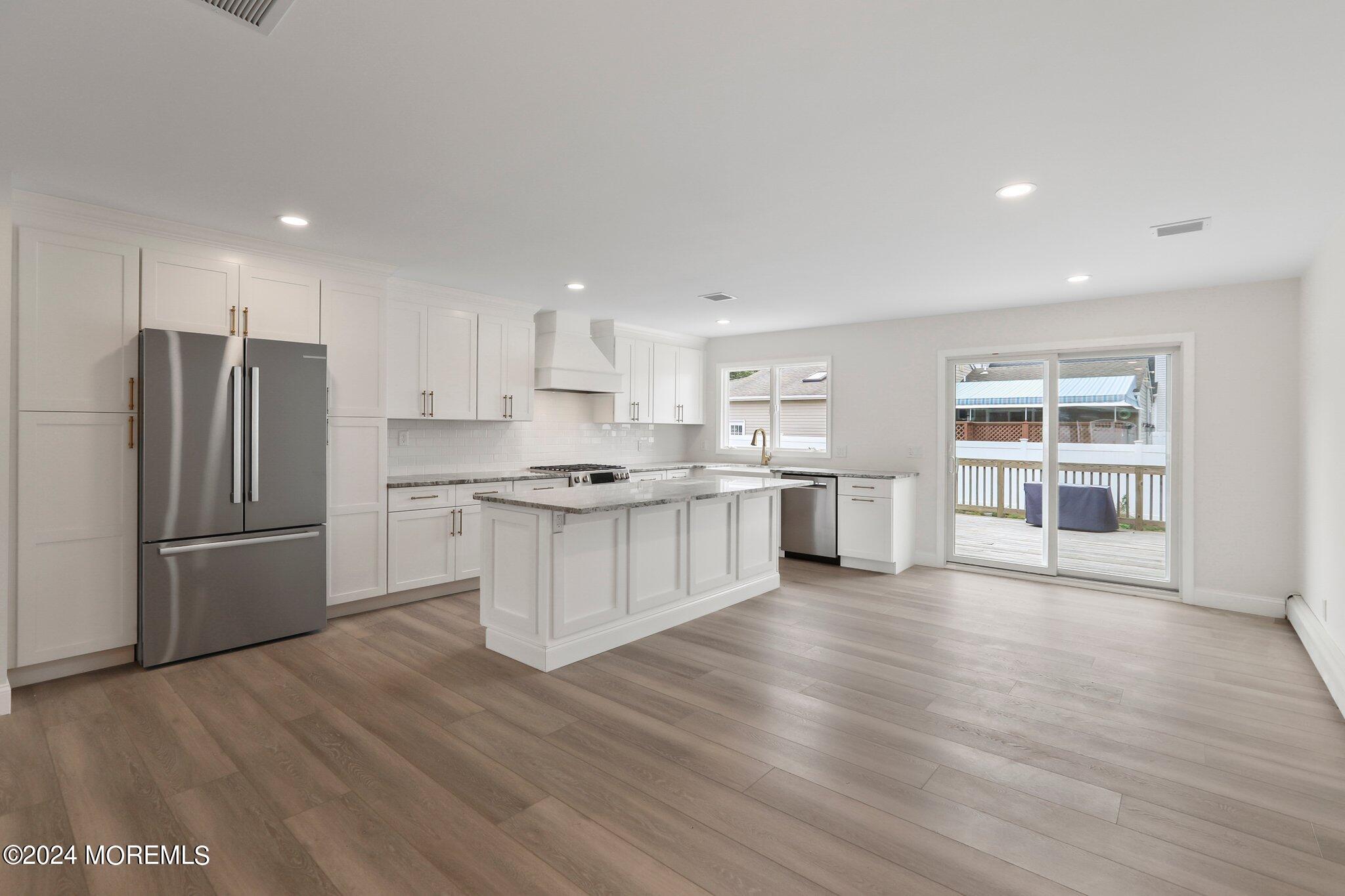 1419 Joseph Street Point Pleasant, NJ 08742 - Photo 5 of 27 a kitchen with stainless steel appliances a refrigerator and wooden floor