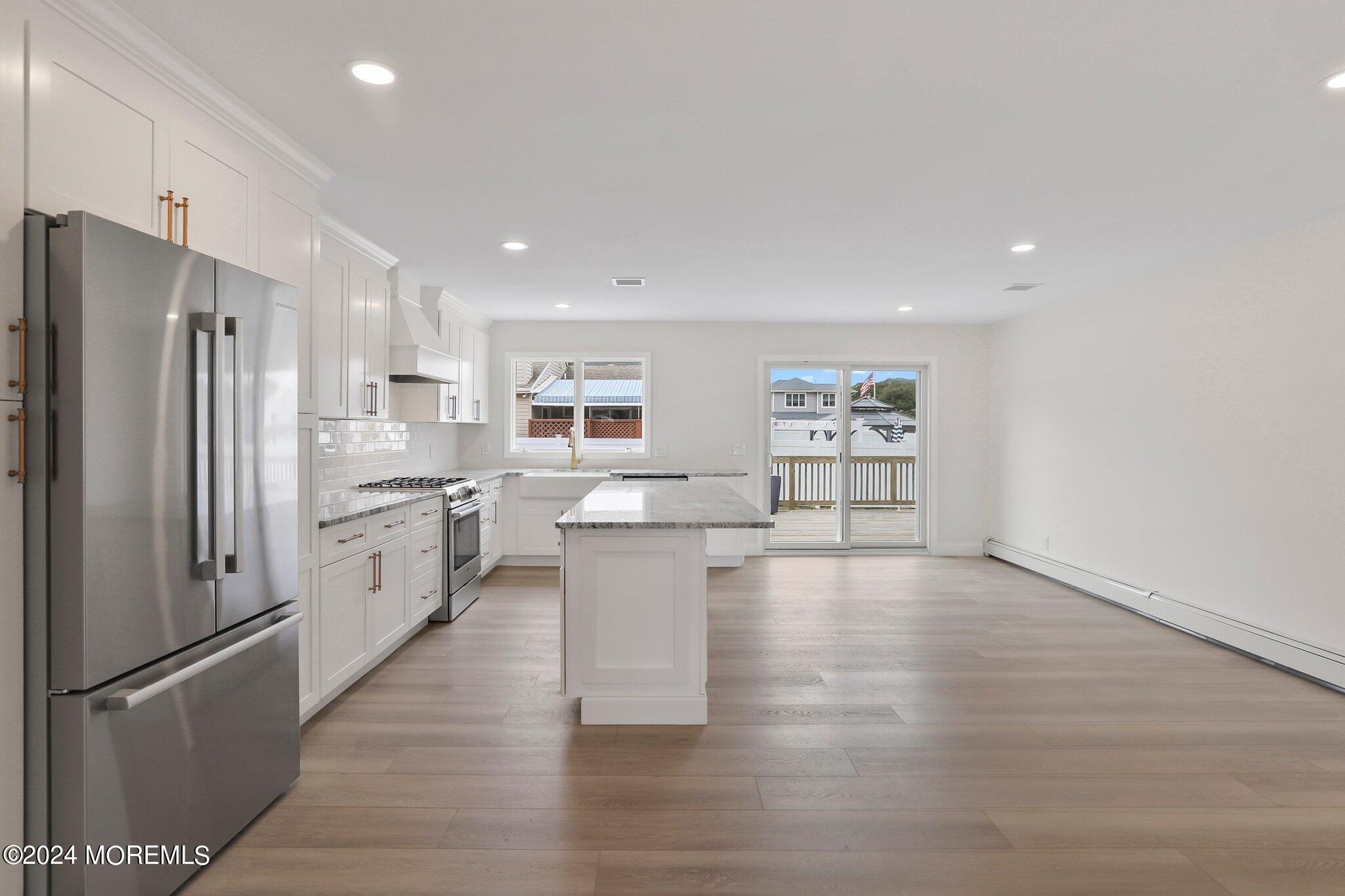 1419 Joseph Street Point Pleasant, NJ 08742 - Photo 6 of 27 a kitchen with stainless steel appliances a refrigerator and a stove top oven