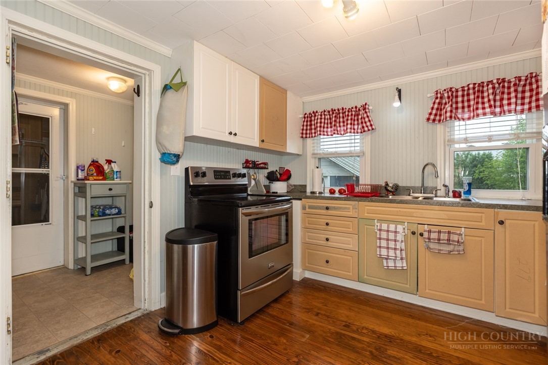 1335 Shingle Gap Road Purlear, NC 28665 - Photo 42 of 49 a kitchen with stainless steel appliances a stove sink and cabinets