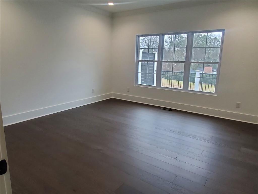 1240 6th Street Northwest Hickory, NC 28601 - Photo 22 of 48 an empty room with wooden floor and windows