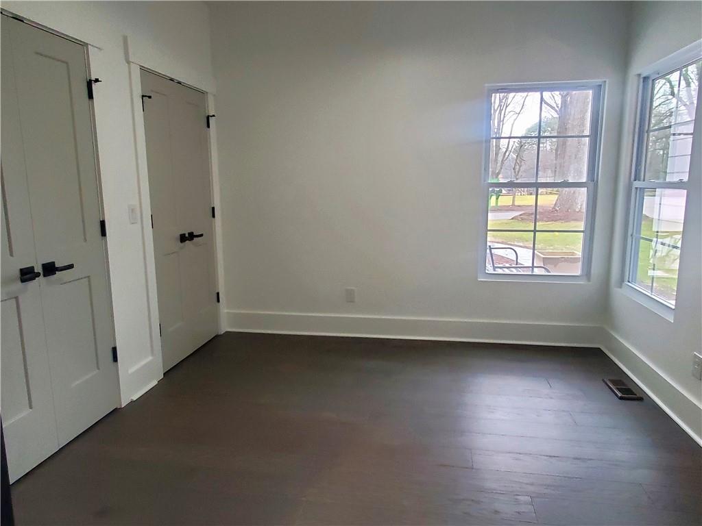 1240 6th Street Northwest Hickory, NC 28601 - Photo 28 of 48 an empty room with wooden floor and windows