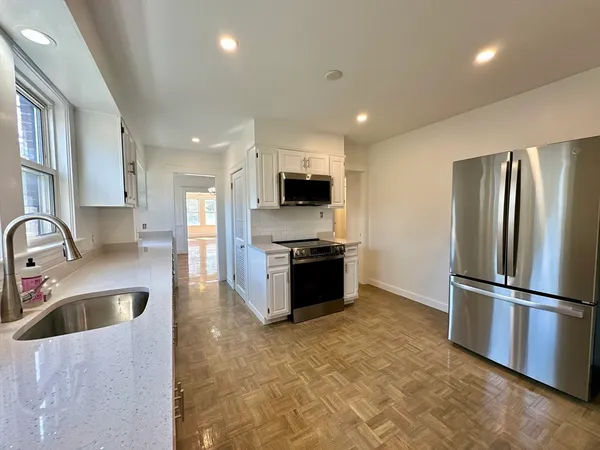 a kitchen with stainless steel appliances granite countertop a refrigerator and a sink
