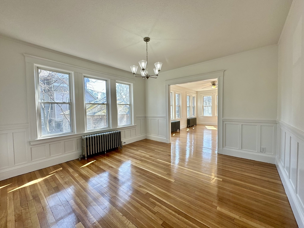 14 Hooper Street, Unit 1 Boston, MA 02124 - Photo 4 of 14 wooden floor in an empty room with a window