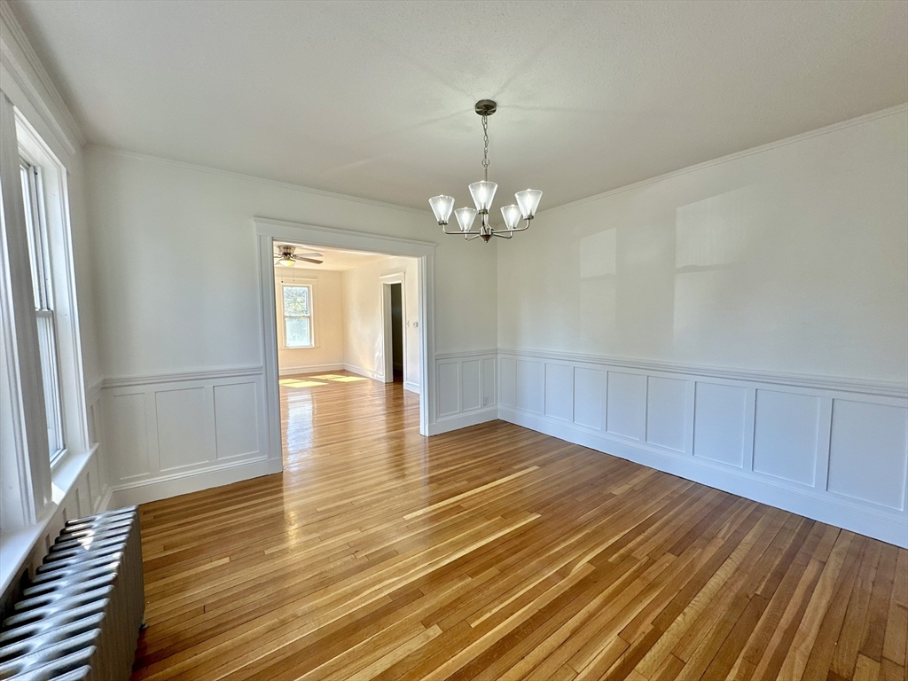 14 Hooper Street, Unit 1 Boston, MA 02124 - Photo 5 of 14 a view of livingroom with kitchen and hardwood