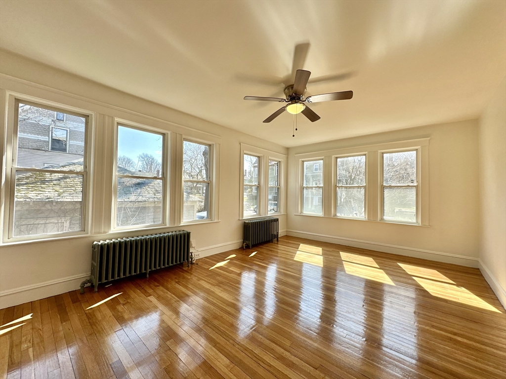 14 Hooper Street, Unit 1 Boston, MA 02124 - Photo 6 of 14 a view of an empty room with a window and wooden floor