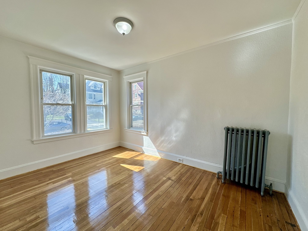 14 Hooper Street, Unit 1 Boston, MA 02124 - Photo 8 of 14 a view of an empty room with wooden floor and a window