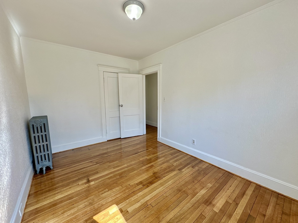 14 Hooper Street, Unit 1 Boston, MA 02124 - Photo 9 of 14 a view of room with wooden floor and chair