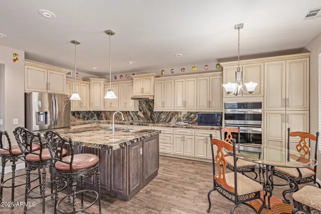 a kitchen with kitchen island granite countertop a stove and white cabinets