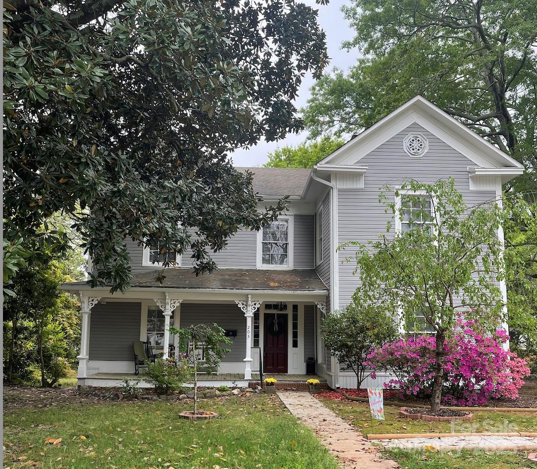 203 Kings Mountain Street Clover, SC 29710 - Photo 1 of 35 a front view of a house with garden
