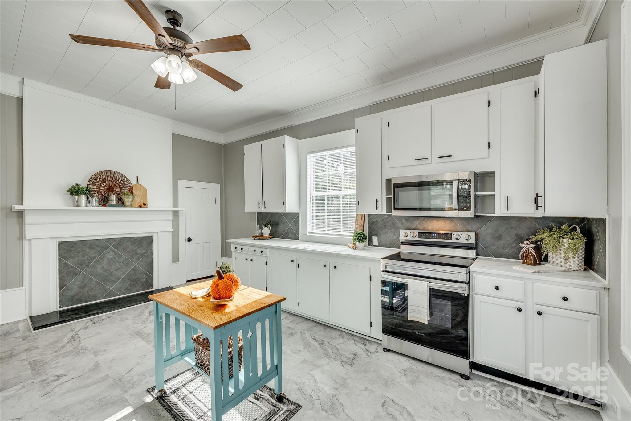 203 Kings Mountain Street Clover, SC 29710 - Photo 13 of 35 a kitchen with stainless steel appliances white cabinets sink and a stove
