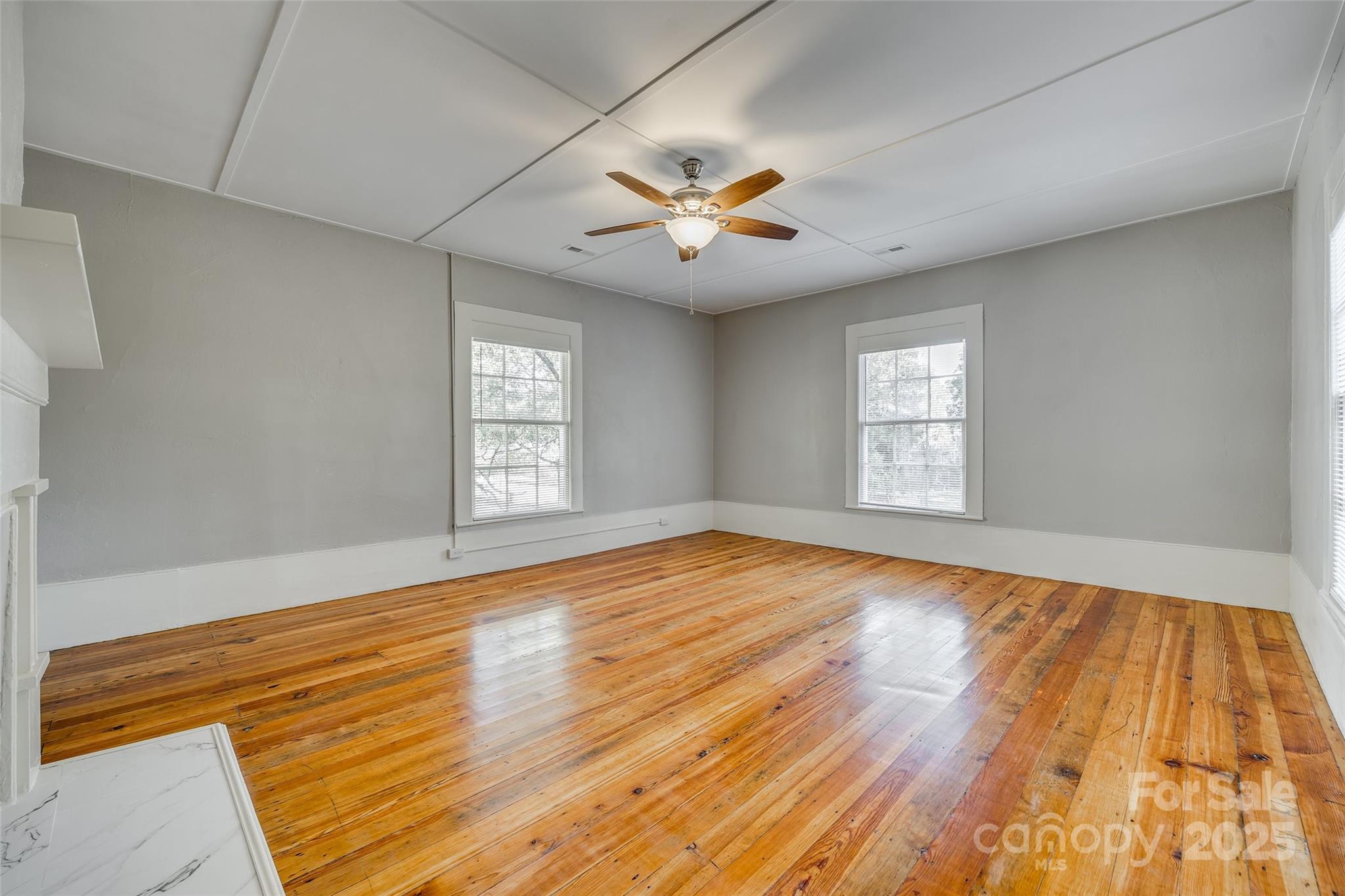 203 Kings Mountain Street Clover, SC 29710 - Photo 21 of 35 an empty room with wooden floor and windows