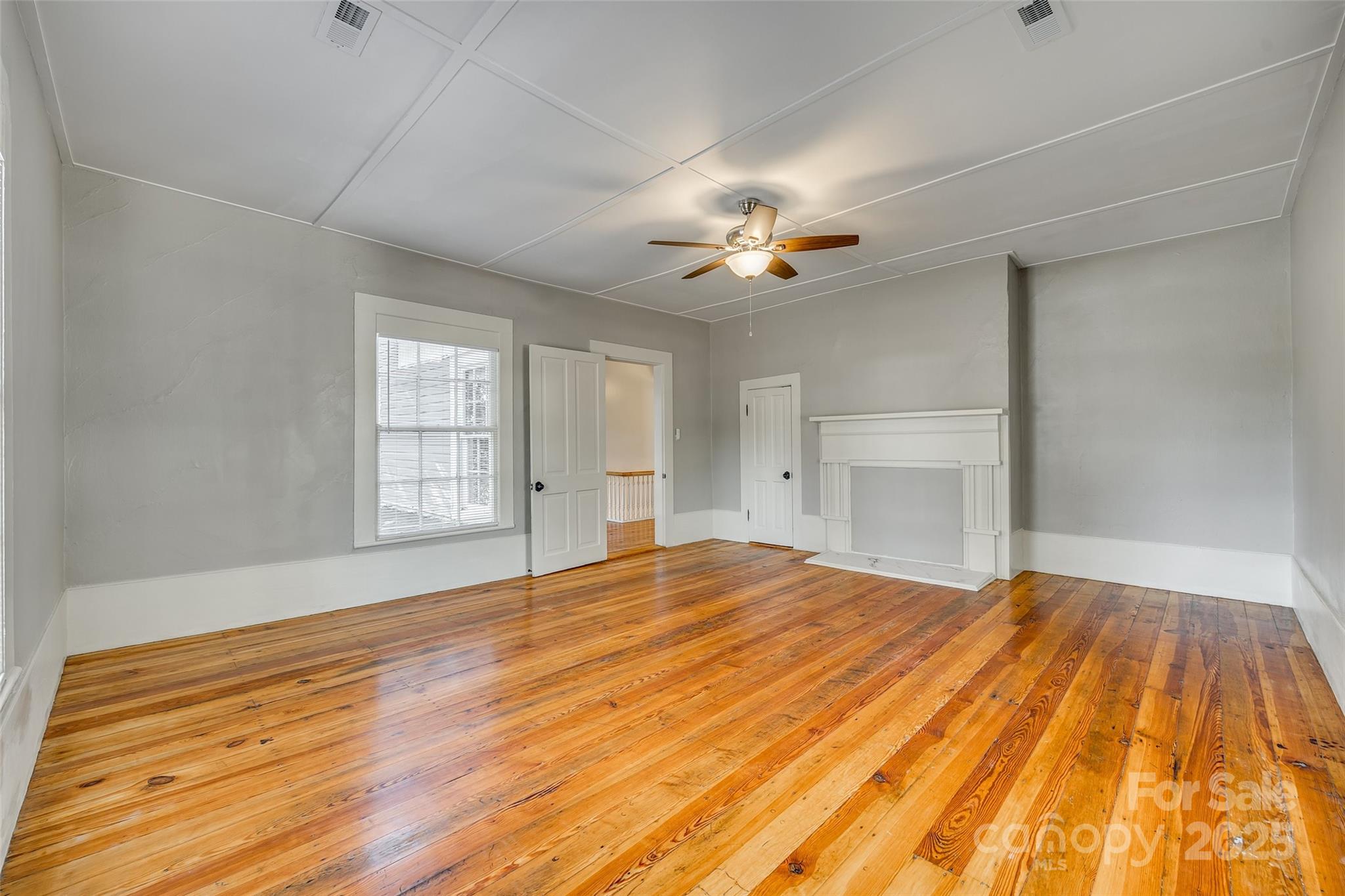 203 Kings Mountain Street Clover, SC 29710 - Photo 22 of 35 a view of an empty room with a fireplace and a window