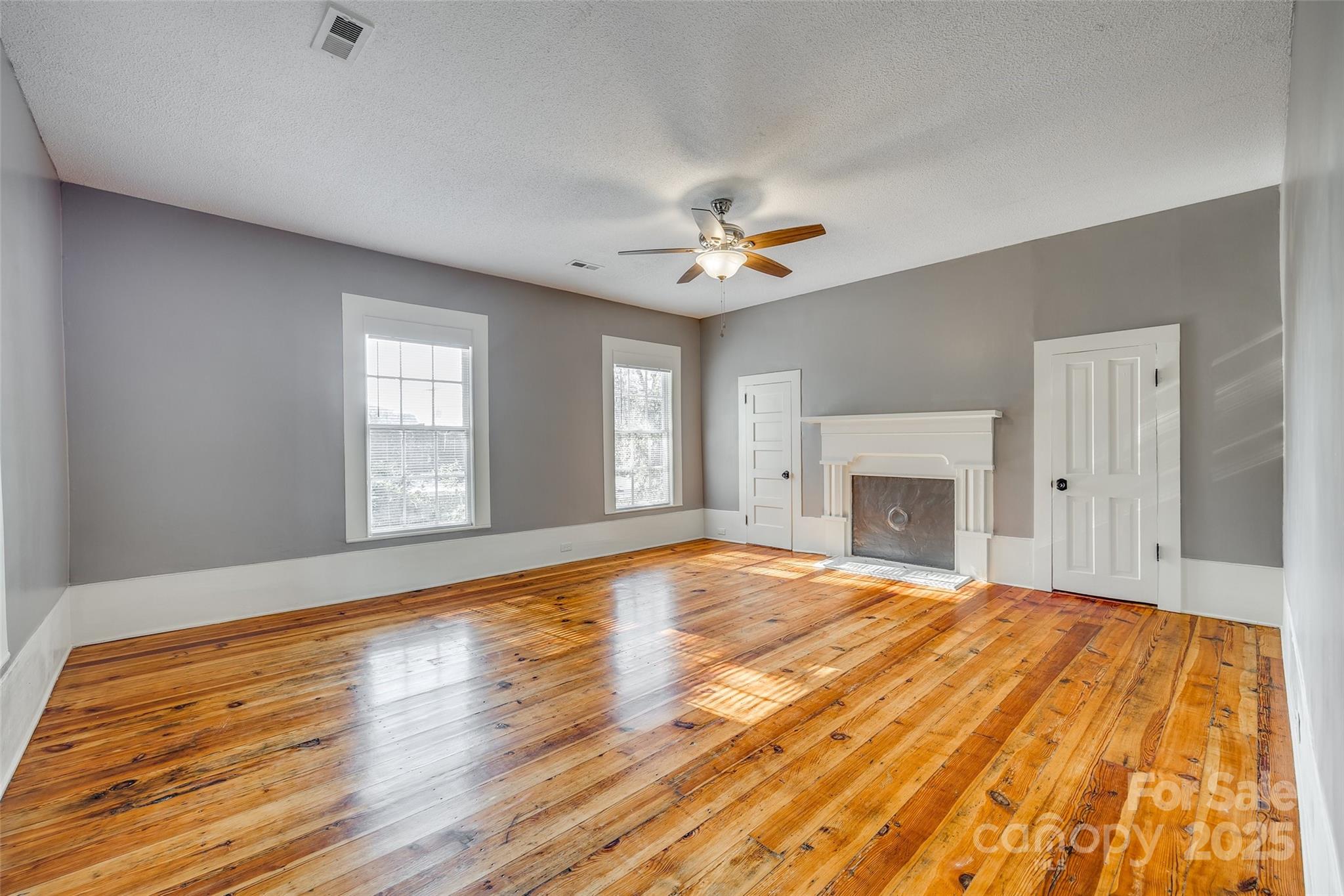 203 Kings Mountain Street Clover, SC 29710 - Photo 23 of 35 a view of empty room with wooden floor and fan