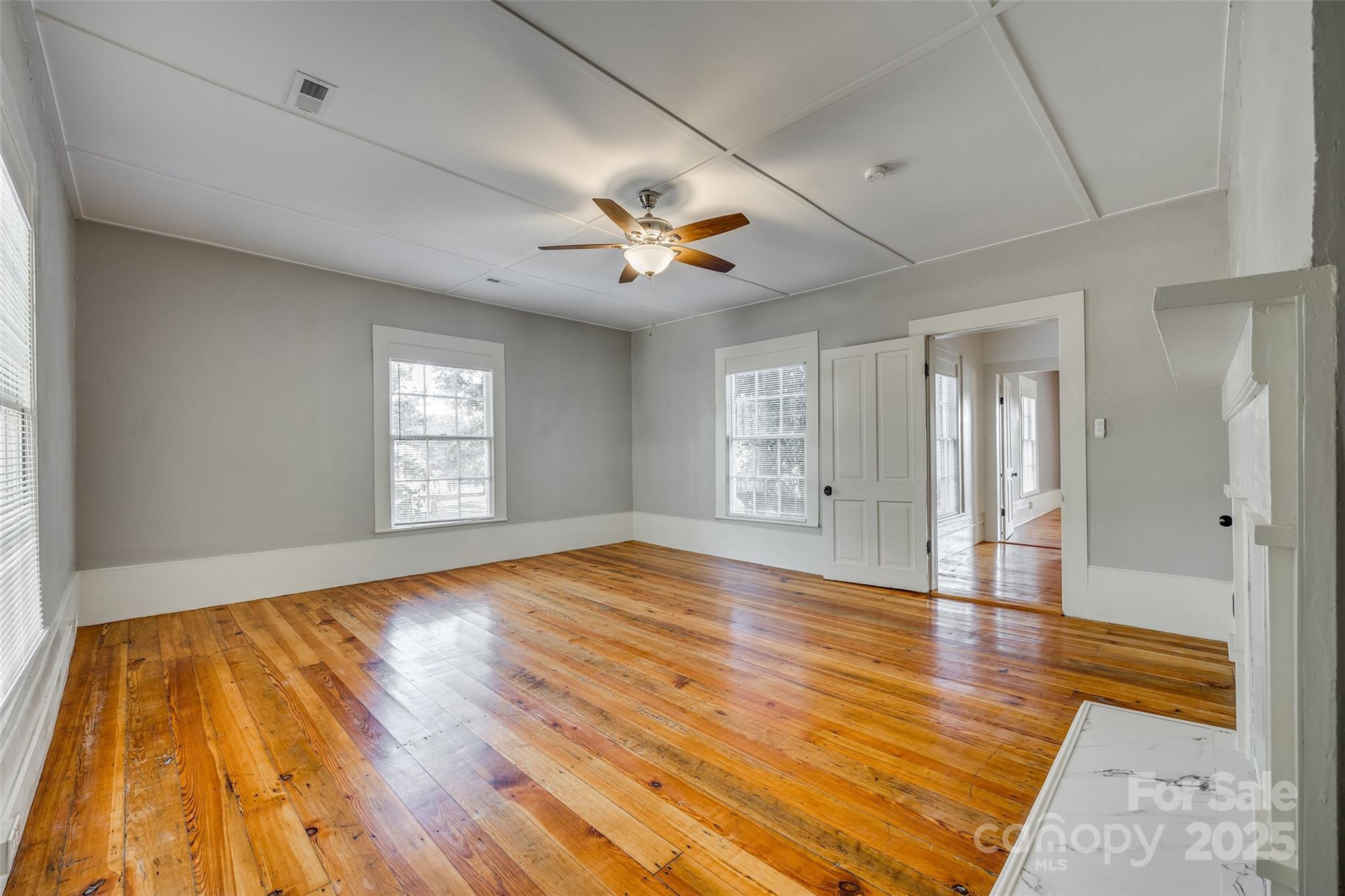 203 Kings Mountain Street Clover, SC 29710 - Photo 24 of 35 a view of empty room with wooden floor and fan