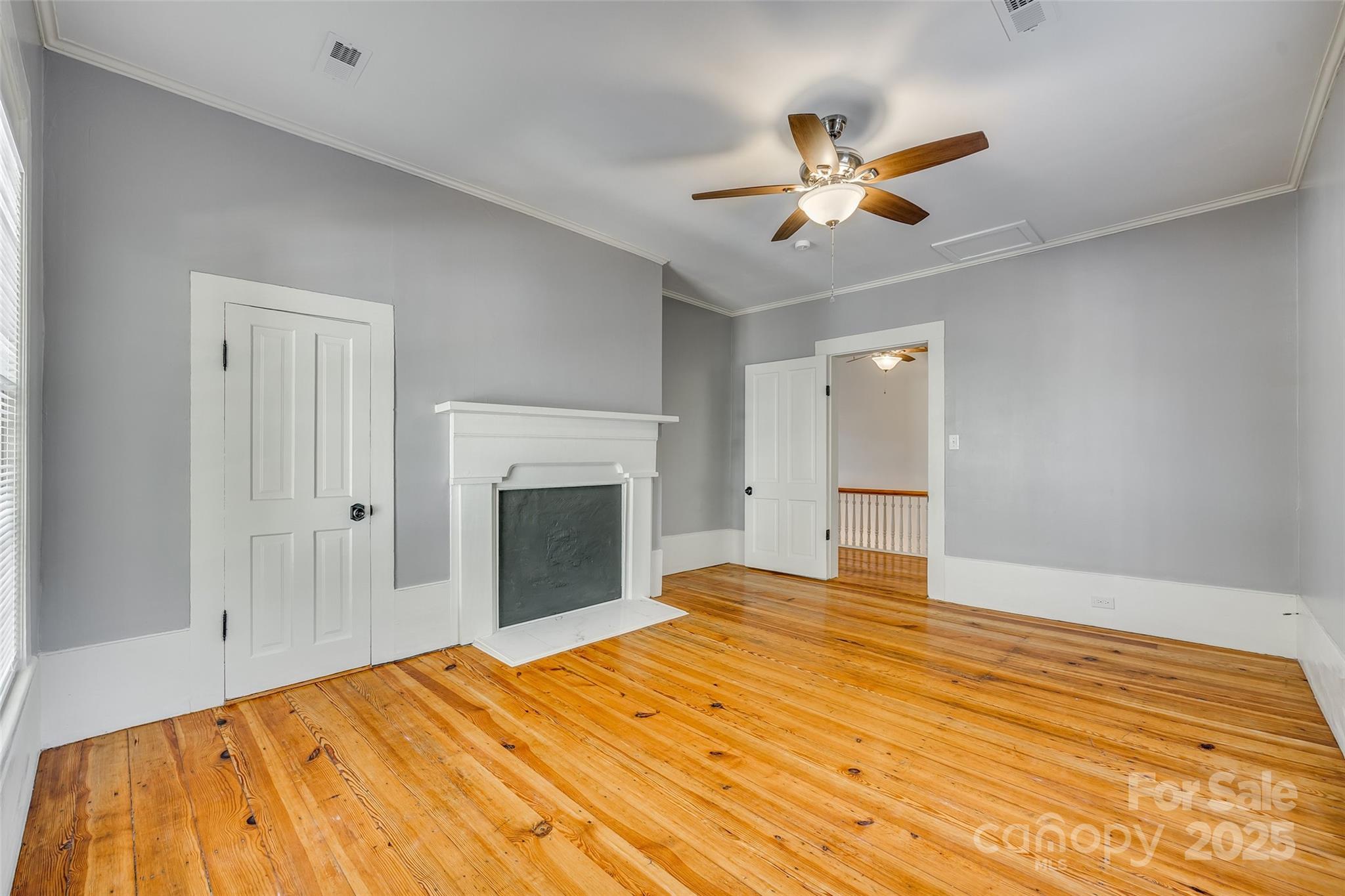 203 Kings Mountain Street Clover, SC 29710 - Photo 28 of 35 a view of an empty room with a ceiling fan and a fireplace