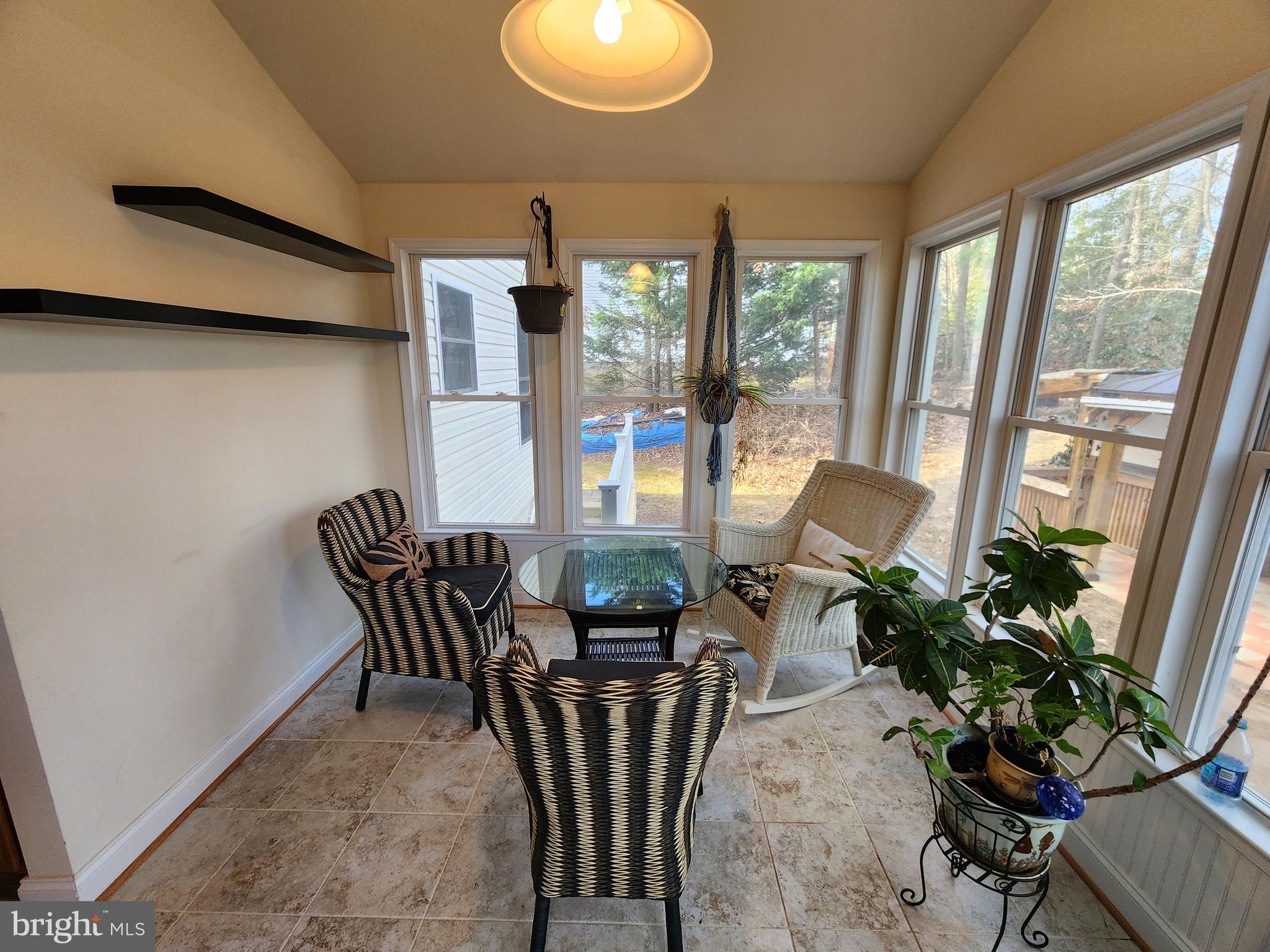 27245 Cat Creek Road Mechanicsville, MD 20659 - Photo 16 of 90 a dining room with furniture potted plants and wooden floor