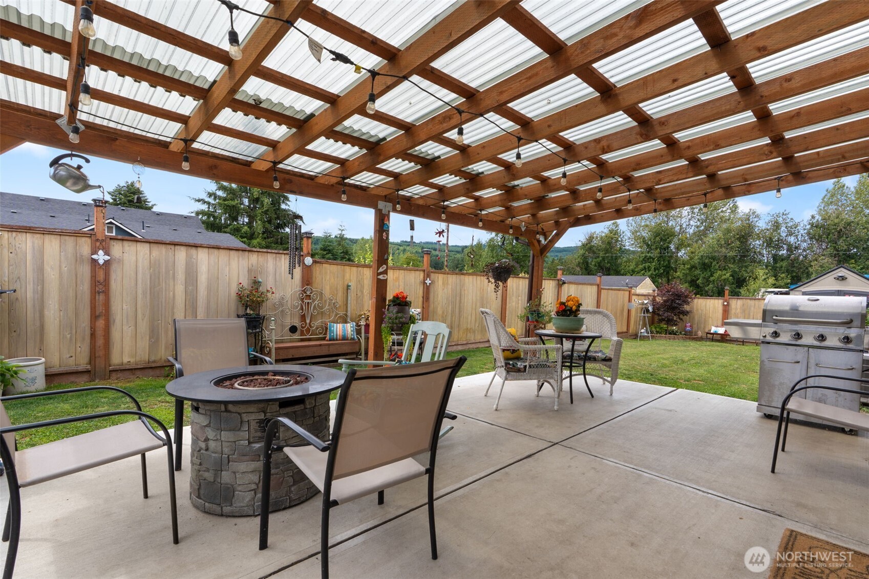 608 Main Street Vader, WA 98593 - Photo 26 of 37 a view of a patio with a table and chairs and a barbeque