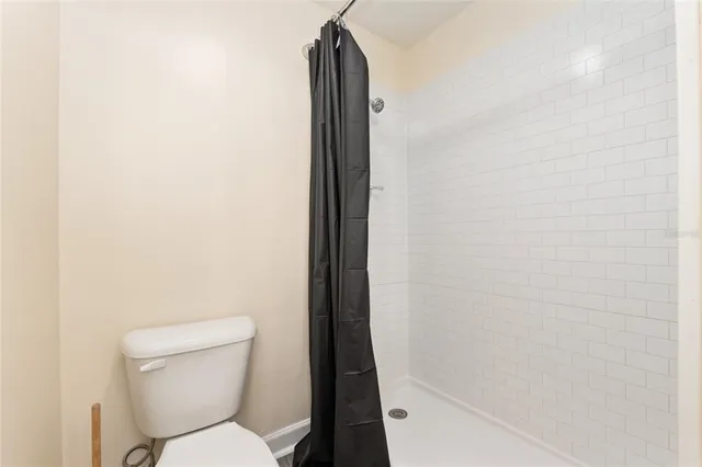 a view of backyard with swimming pool and seating space