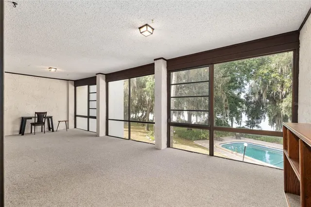 an aerial view of a houses with a yard and lake view