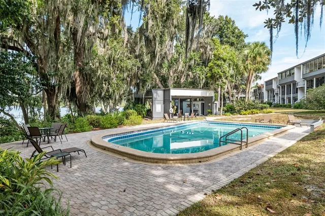 an aerial view of a residential houses with outdoor space and lake view