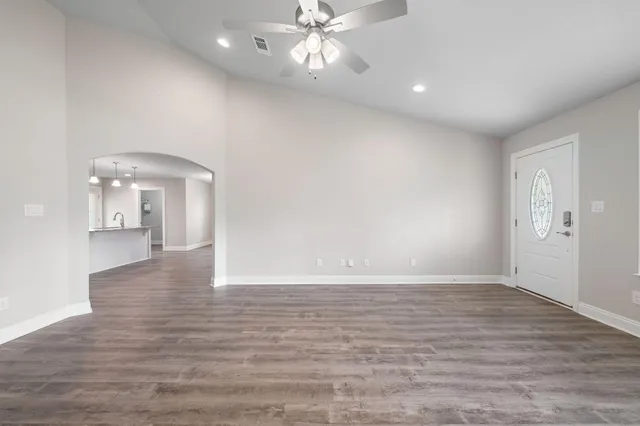 a kitchen with granite countertop stainless steel appliances a sink cabinets a refrigerator and a stove