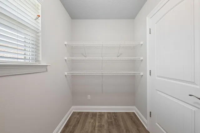 a bathroom with a granite countertop sink a mirror and shower