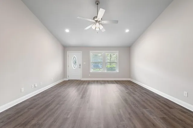 wooden floor in an empty room with a window