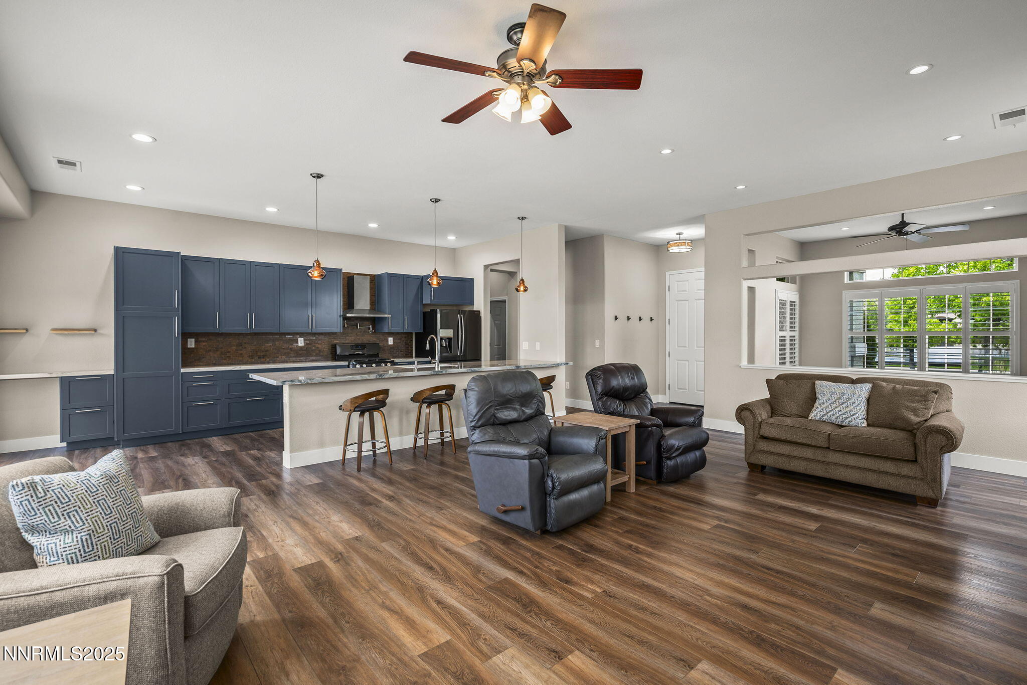 1660 Murrieta Court Reno, NV 89521 - Photo 11 of 39 a living room with furniture kitchen area and a wooden floor