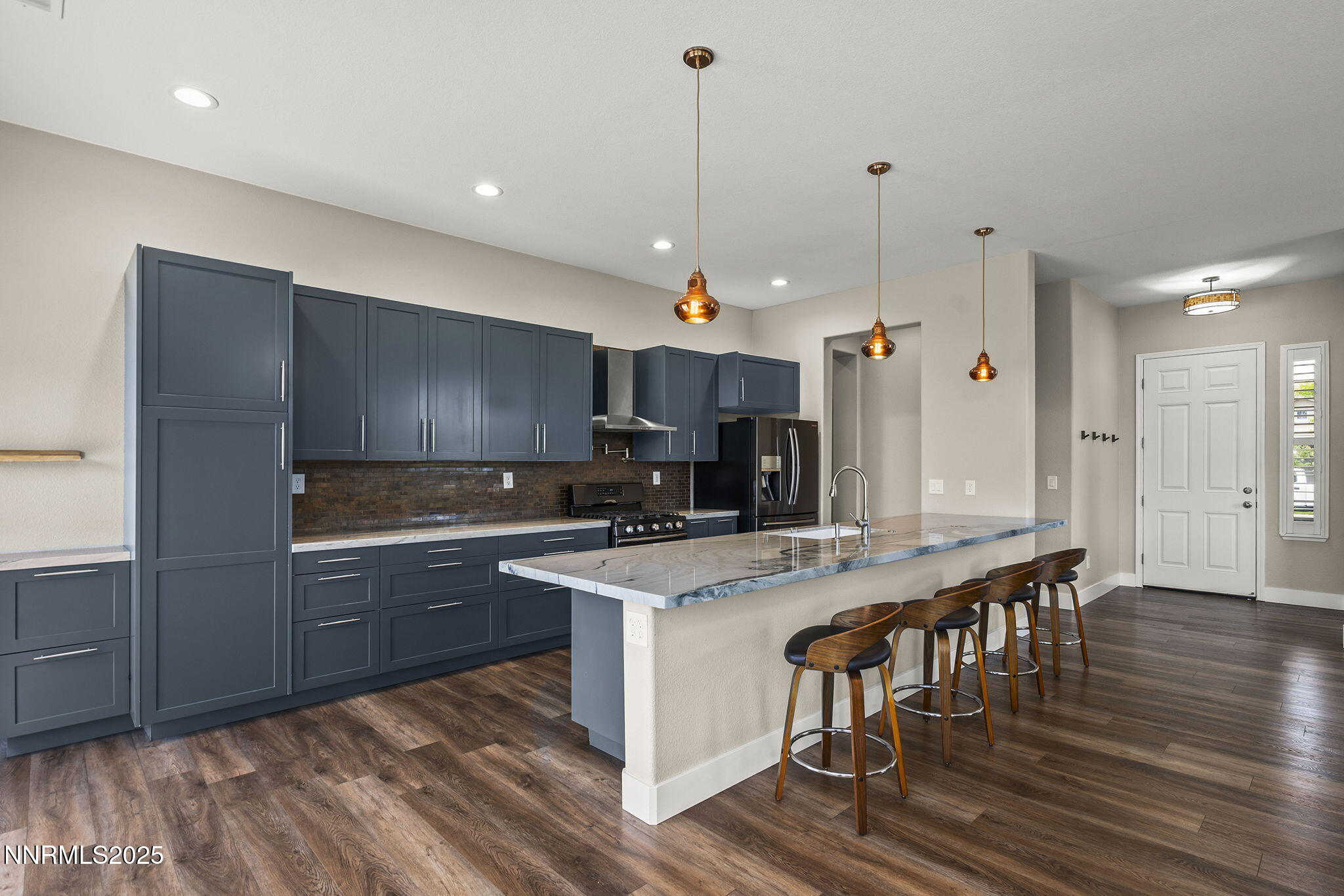 1660 Murrieta Court Reno, NV 89521 - Photo 12 of 39 a large kitchen with stainless steel appliances granite countertop a stove a refrigerator a oven a sink with island and chairs
