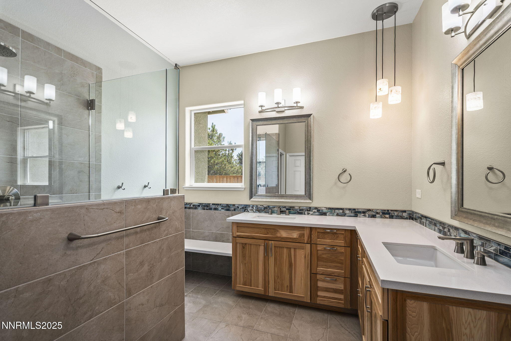1660 Murrieta Court Reno, NV 89521 - Photo 19 of 39 a bathroom with a granite countertop sink a large mirror and a bathtub