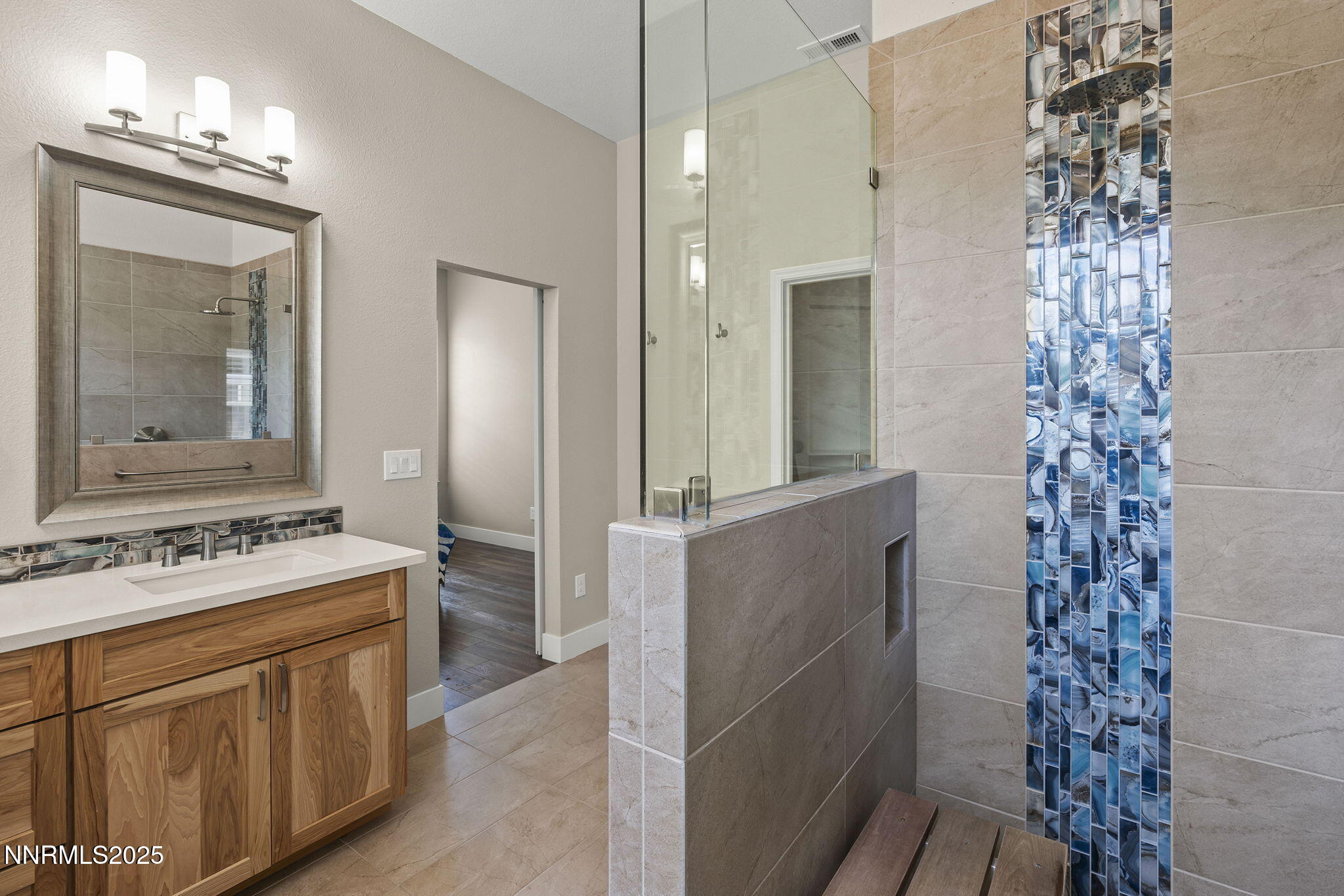 1660 Murrieta Court Reno, NV 89521 - Photo 20 of 39 a bathroom with a sink a mirror and a shower