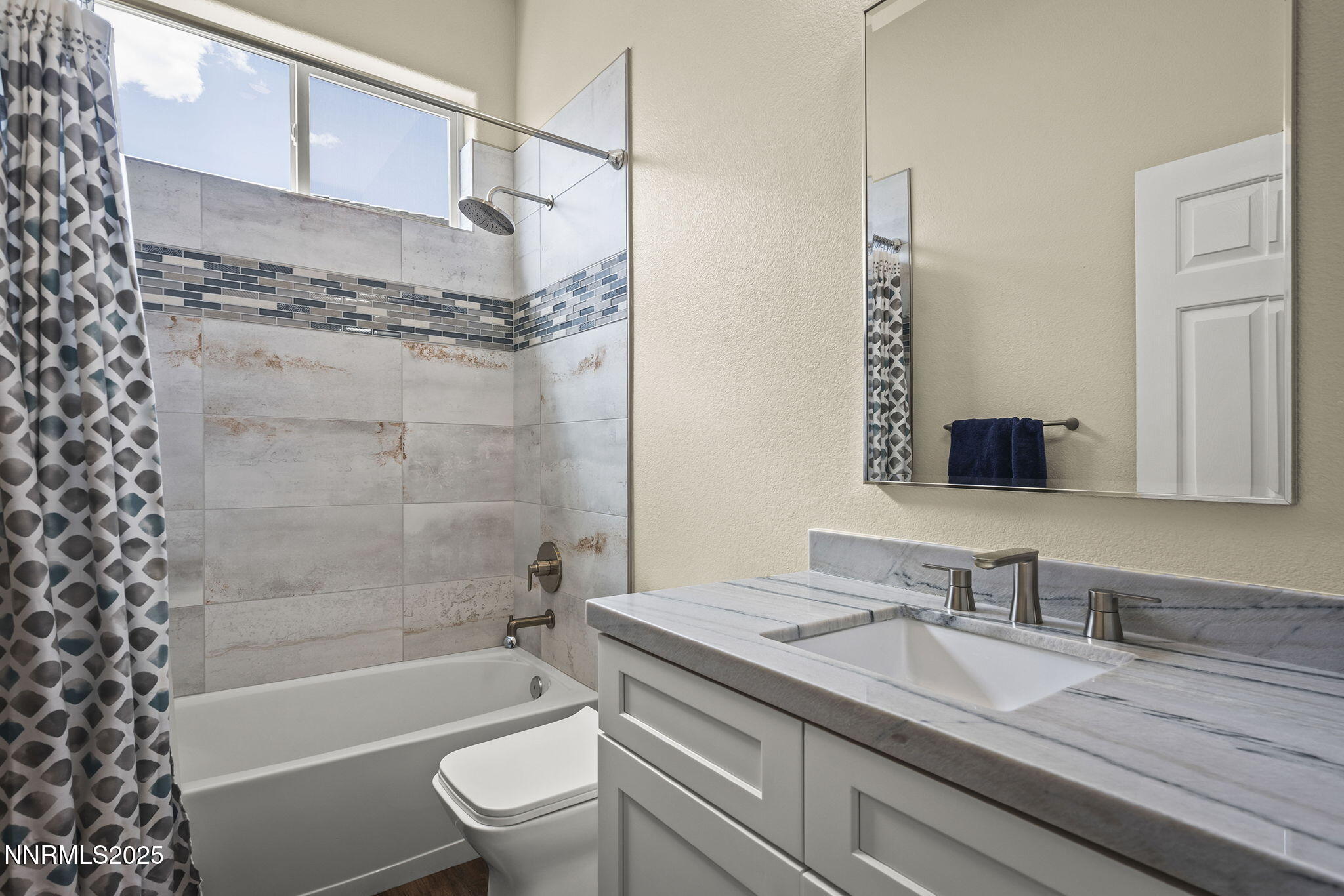 1660 Murrieta Court Reno, NV 89521 - Photo 24 of 39 a bathroom with a granite countertop sink a toilet and shower