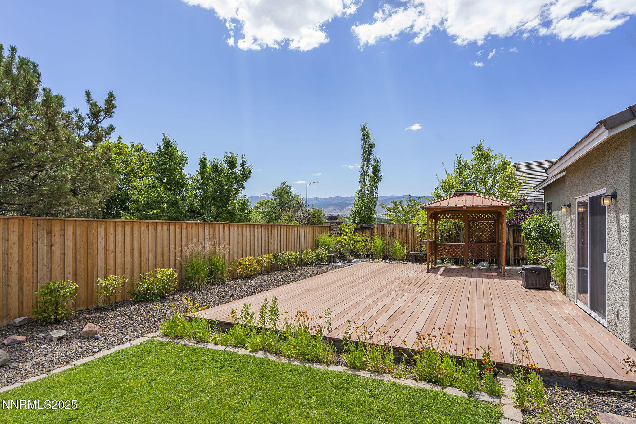 1660 Murrieta Court Reno, NV 89521 - Photo 29 of 39 a view of a backyard with potted plants and wooden fence