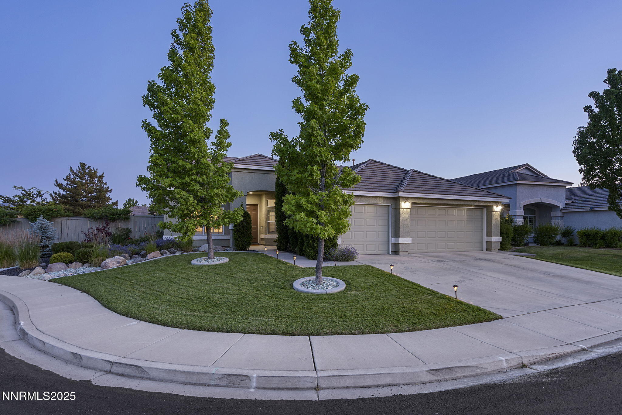 1660 Murrieta Court Reno, NV 89521 - Photo 3 of 39 a view of a white house with a yard and potted plants