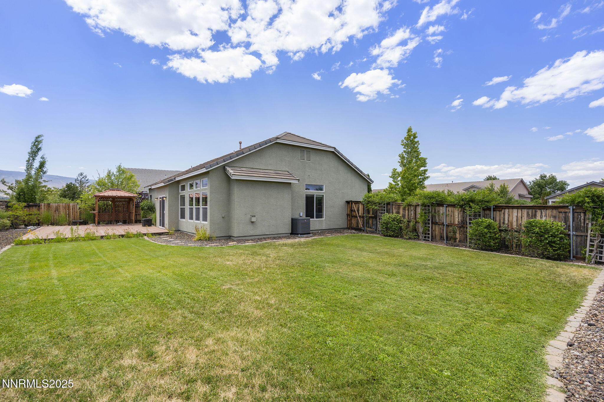 1660 Murrieta Court Reno, NV 89521 - Photo 33 of 39 a yellow house with garden in front of it